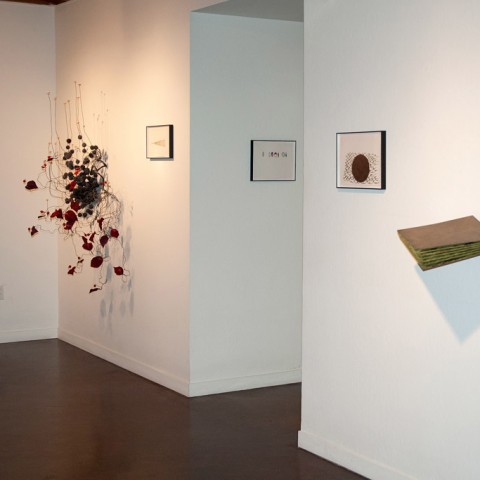 Background: Robert Ortbal - <b>Architecture of a Scent: Cinnamon</b>,  2012, wire, dissected fake flower parts, seed pods, cork, foil, tool dip, heat shrink, paint and flock, 59 x 44 x 29; Foreground: <b> Layers-more like chapters</b>, 2013, masonite, paint and flock, 22 x 22.5 x 10